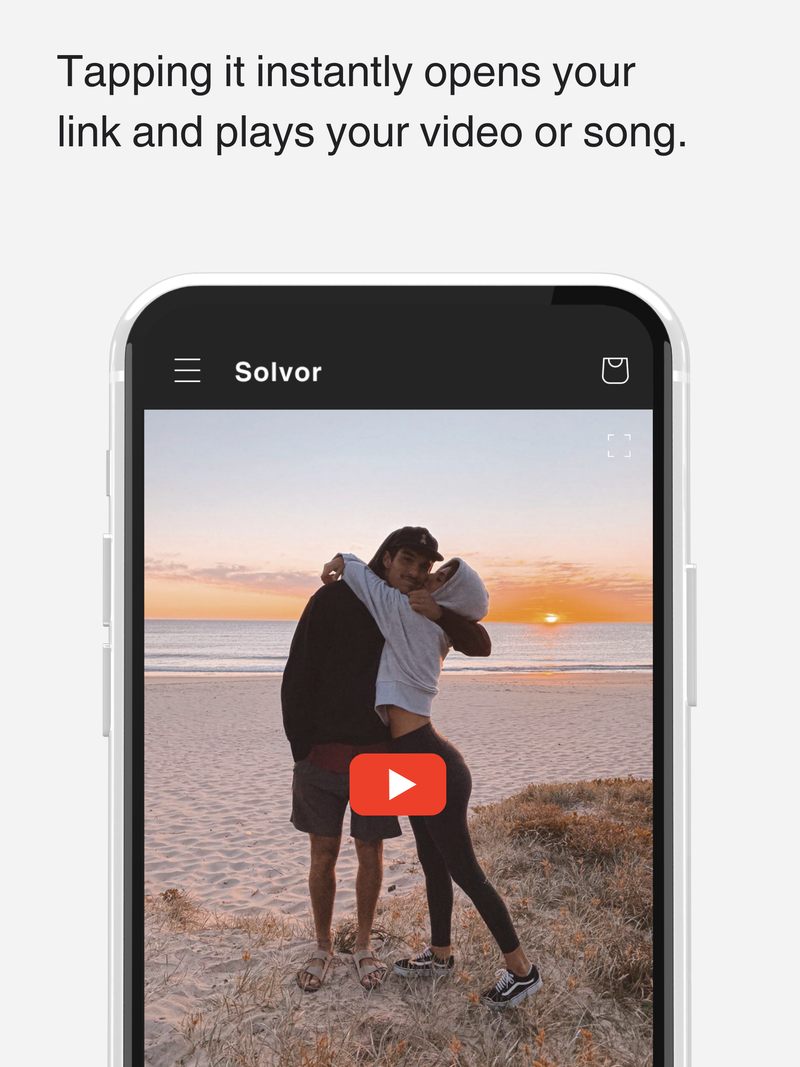 Tapping it instantly opens your link and plays your video or song. Phone screen displaying a couple on a beach with the Solvor website interface.